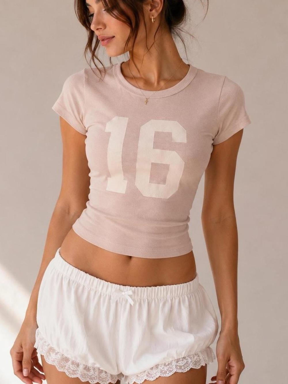 Brandy Melville Women’s Blush Pink Number 16 cropped Tee